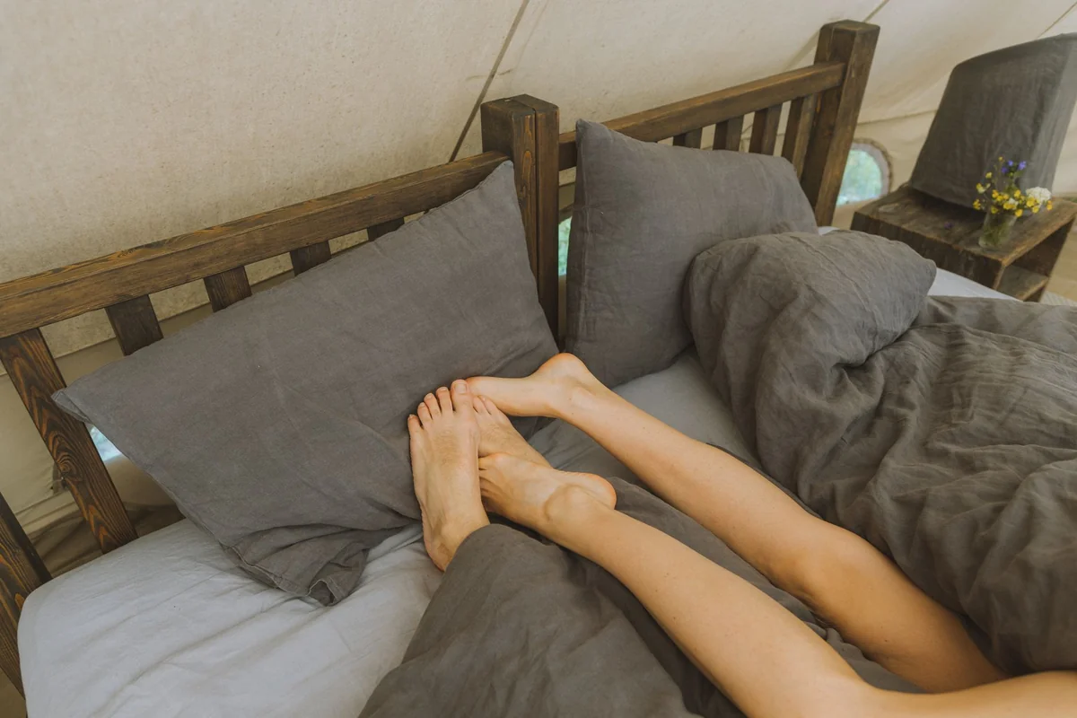 A couple relaxing together in bed, showcasing a peaceful morning vibe.