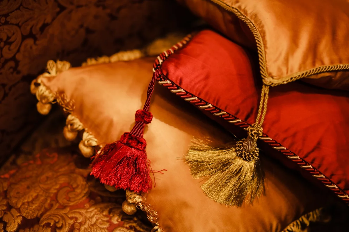 Elegant velvet cushions with decorative tassels add a touch of luxury to any interior space.